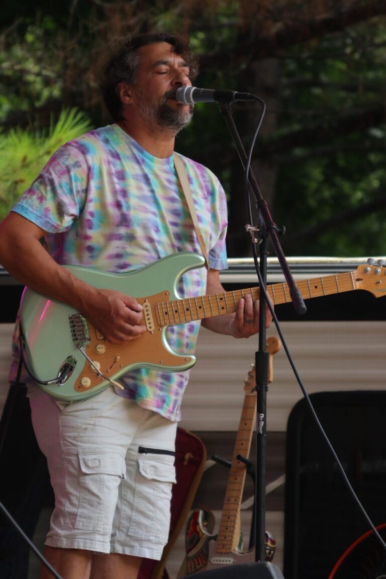 Jeremy Pinell playing lead guitar at an outdoor Zentrance show