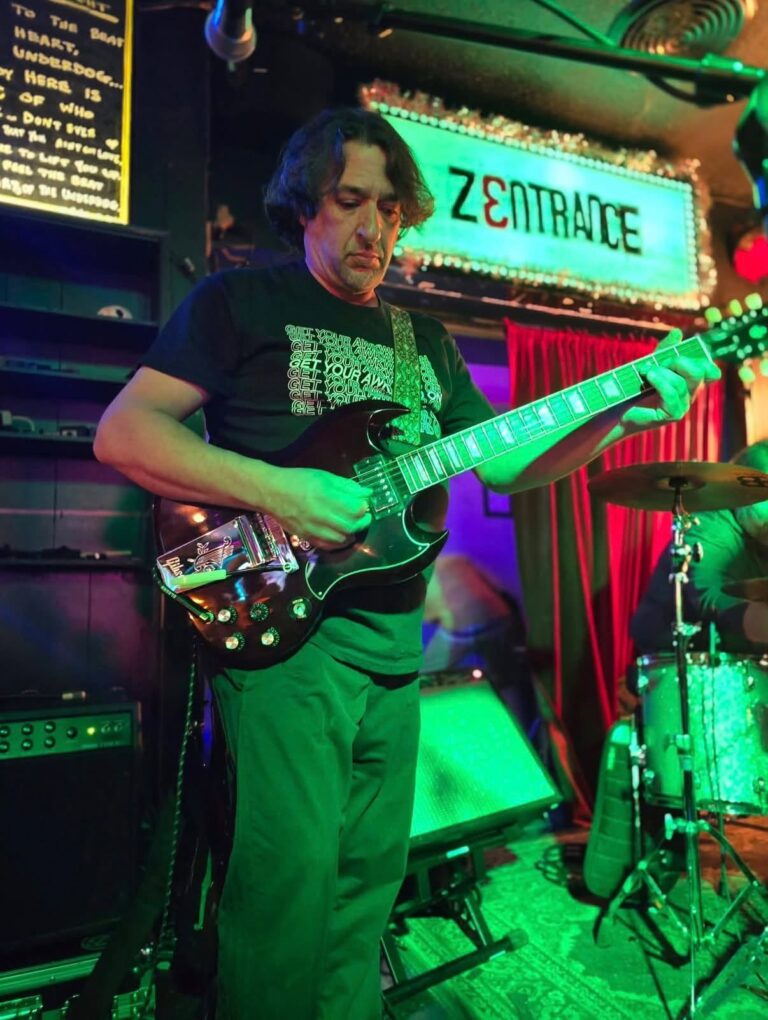 Jeremy Pinell playing lead guitar live with Zentrance