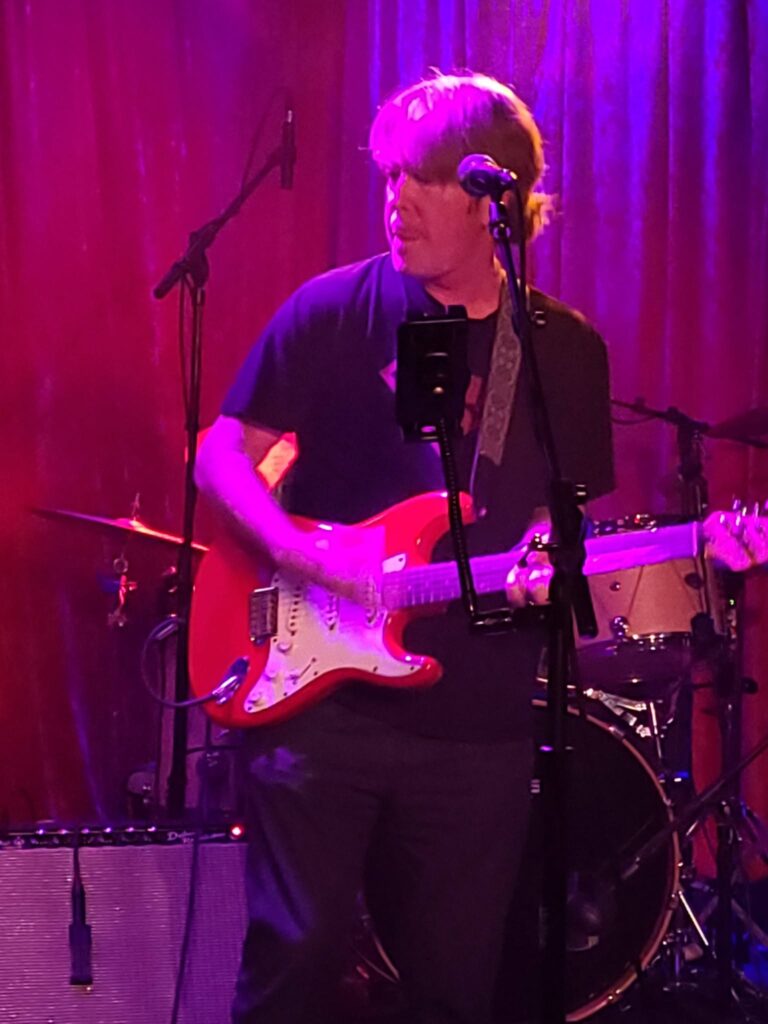 Ron Cook singing and playing guitar at The 5 Spot