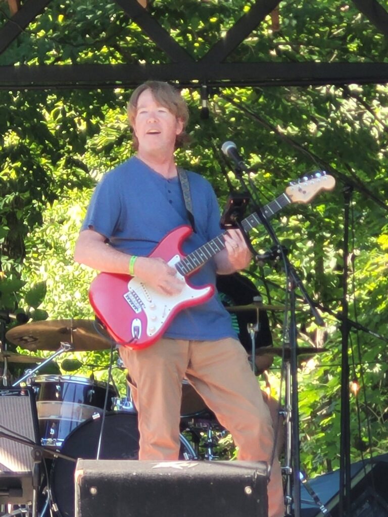 Ron Cook with his red guitar at the Summer Solstice show