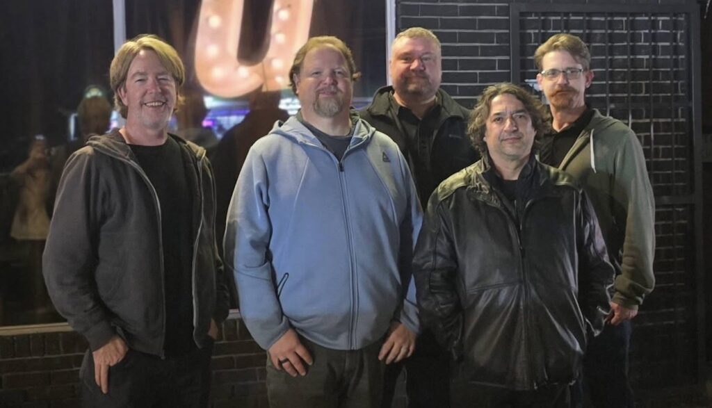 The five members of Zentrance posing together outside at night